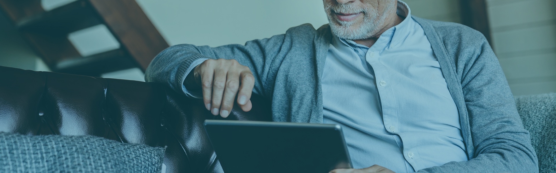 Man reading on tablet reading newsletters