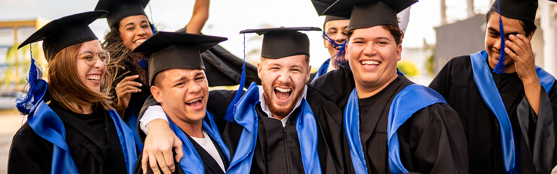 Group of graduates celebrating for student loans page.
